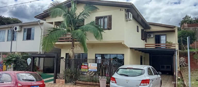 a house with a palm tree and a gate