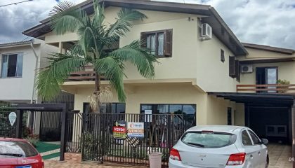 a house with a palm tree and a gate